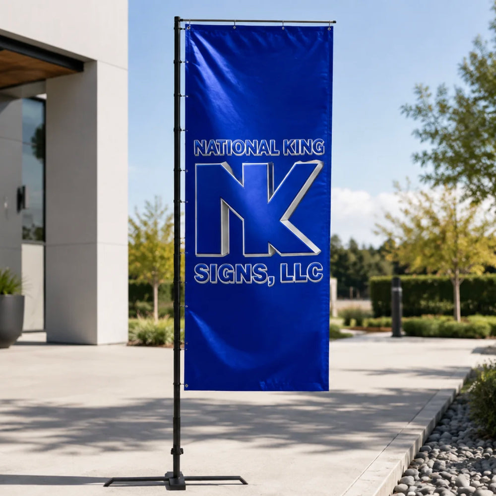 National King Signs branded blue rectangular promotional flag on a black pole with cross base outside a modern building.